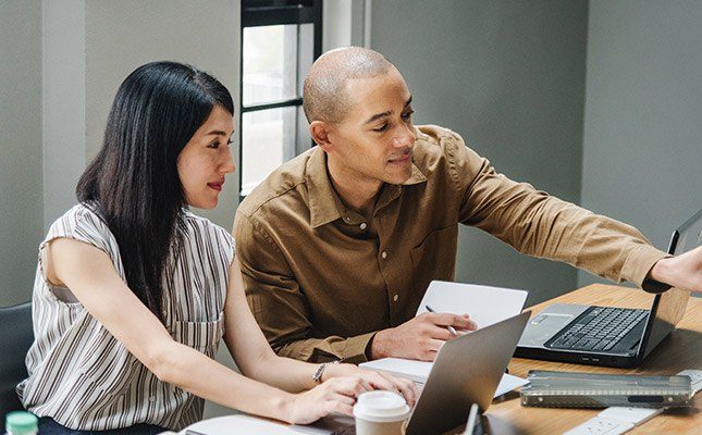 Professionals in Sydney office discussing their government website project
