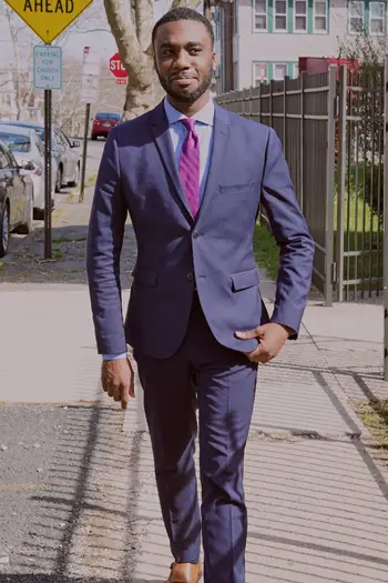 18. Professional man in suit walking outside and smiling