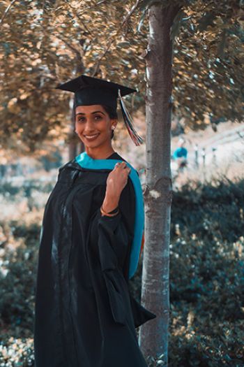 9. Young university graduate in her graduation gown