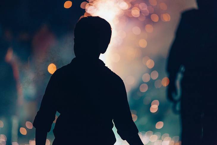 High contrast silhouette of a boy at night