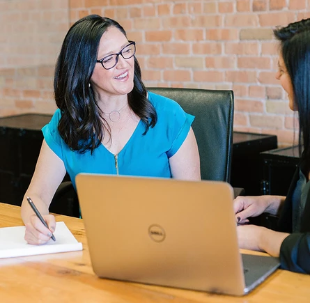 Two professional woman in an office creating a new persona